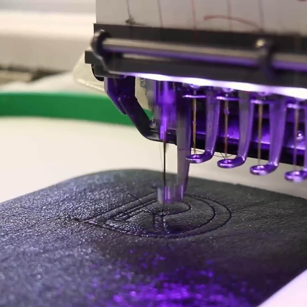 Machine embroidery of a logo into leather